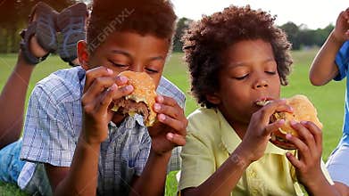Three black boys are having breakfast.
