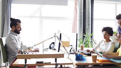 Happy creative team with computers in office