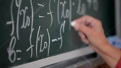 Formula written on blackboard with chalk