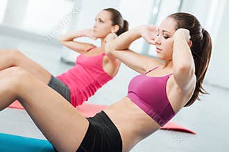 Young women doing abs workout at the gym