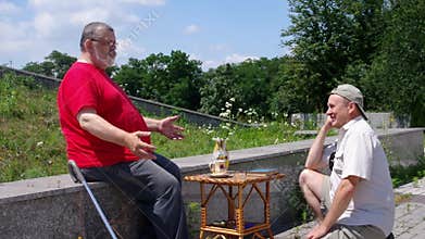 Senior man tells a funny story to his friend