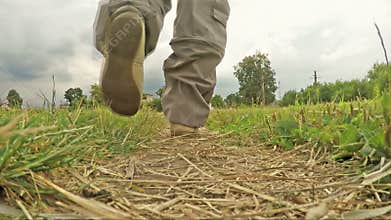 Man walking along a footpath in the countryside