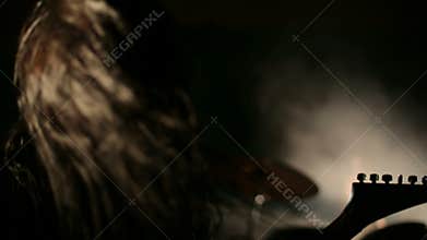 Vocalist and drummer of black metal band at dark background