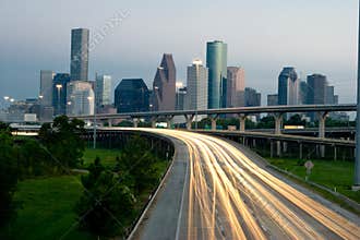 City skyline at dusk with traffic