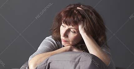 Resigned senior woman sick of having menopause blues