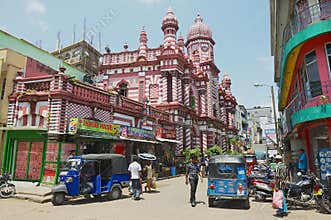 People walk by the street with colonial architecture building at the background in downtown Colombo, Sri Lanka.
