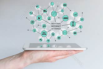 Industrial internet of things IOT concept. Male hand holding modern smart phone or tablet