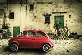 Old vintage italian scene. Small antique red car. Aging effect