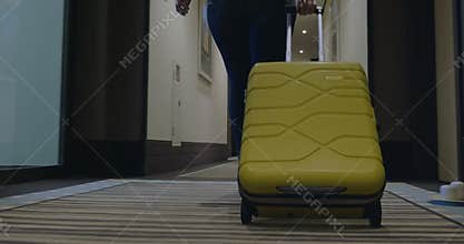 Woman with trolley bag looking for room in hotel