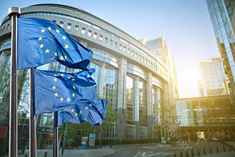 European union flag against parliament in Brussels