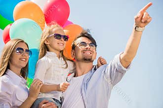 Family with balloons outdoors