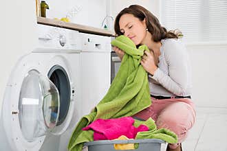 Woman With Clothes Near The Washer