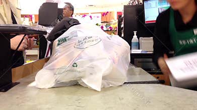Customer paying for groceries at checkout counter