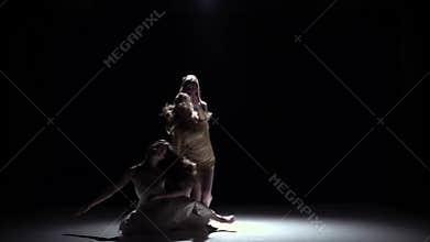 Contemporary dance performance of five girls in white dresses, on black, shadow, slow motion