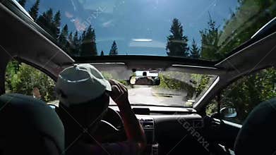 Man driving a car on country road