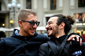 Gay couple smiling on the streets of Florence , Italy