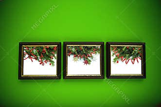 Christmas frames on green wall