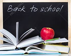 Back to school concept blackboard open books & apple.