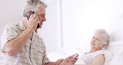 Senior man on phone call holding pills