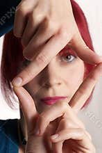 Woman framing face with fingers