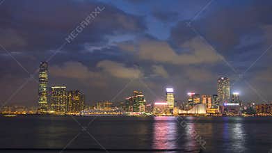 Shyline panorama timelapse day to night with International Commerce Centre in West Kowloon, Hong Kong.
