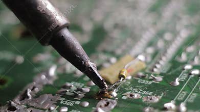 A soldering iron in his hands