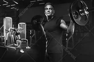 Young and fit couple in the gym doing workout