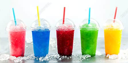 Row of Frozen Fruit Slushies in Plastic Cups