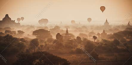 Balloons fly over thousand of temples in sunrise in Bagan, Myanmar