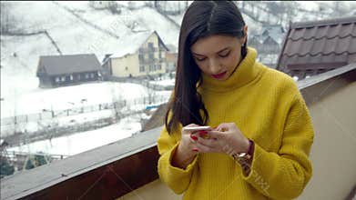 Beautiful young girl writing a text message on the phone