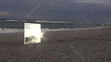 Square mirror on the beach