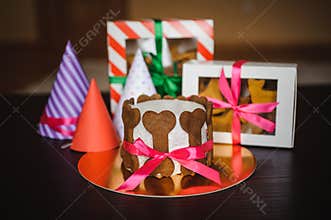 Dog cake and cookie in boxes with birthday hat