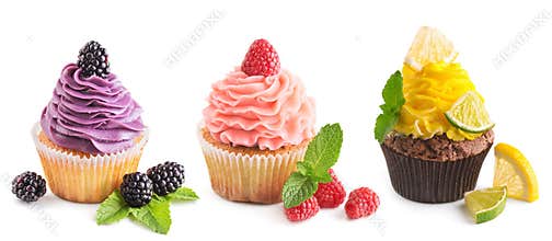 Collection of bright cupcakes with fresh berries isolated on whi