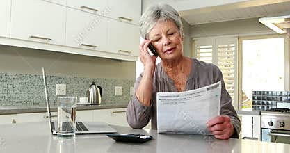 Happy woman using a calculator