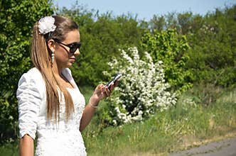Bride makes call on mobile phone
