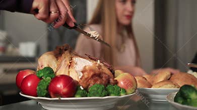 Grandfather carving Thanksgiving turkey