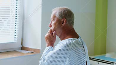 Thoughtful senior man sitting on a bed