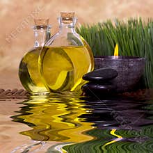 Massage oils and candle with green grass