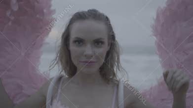 Beautiful angel woman with pink wings