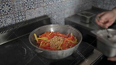 Beans are added to the vegetables pot.