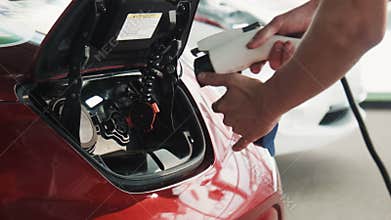 ZAPOROZHYE, UKRAINE - JULY 30, 2016: Red electric car closeup on the charging point