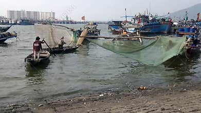 View of Vietnamese fishermen and his boat leaving the dockside, Da Nang