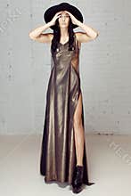 The girl in gold dress and black hat