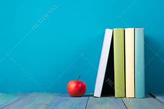 Row of colorful books, grungy blue background, free copy space