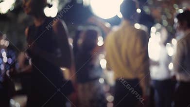 Young people are dancing and having fun. Wedding party. Disco ball is spinning and shining brightly. Slow motion