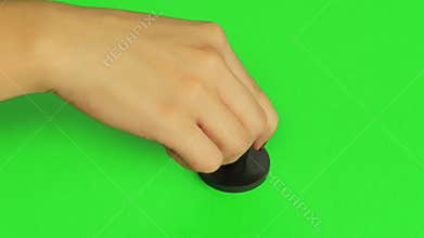 Woman stamps stamp. Close up. Green screen