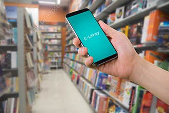 Human right hand hold smart phone, tablet, cellphone with virtual app e-library on blurry bookshelf in bookstore