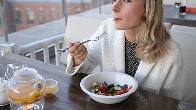 Healthy lifestyle woman eating salad smiling happy outdoors on beautiful day.
