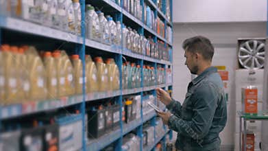 Manager With Tablet PC Checking Goods At Car Supermarket Warehouse shop