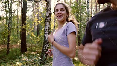Young couple enjoying their gentle run in the forest